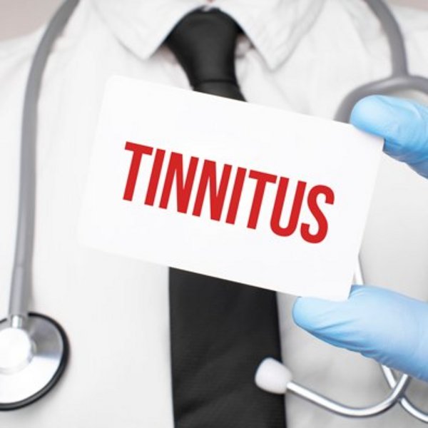doctor-holding-a-card-with-text-tinnitus-medical-concept.jpg